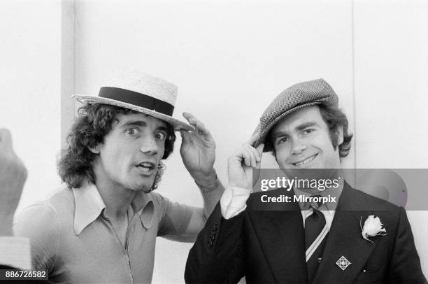 Kevin Keegan in a straw boater hat and Elton John in his own hat. They are pictured prior to leaving Luton Airport for Denmark with the England team,...