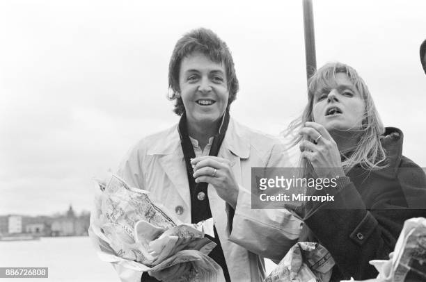 Paul McCartney and his wife Linda of pop group Wings sailing down the River Thames together with Denny Laine as the three of them promote the band's...