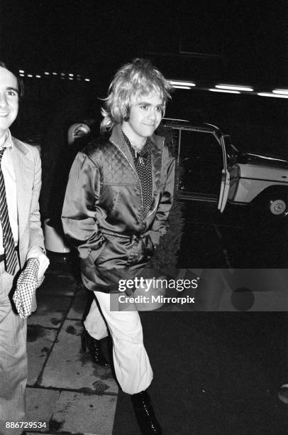 Elton John wearing a woman's wig, seen arriving at a party to celebrate his London show at Legends Club, 3rd April 1979.