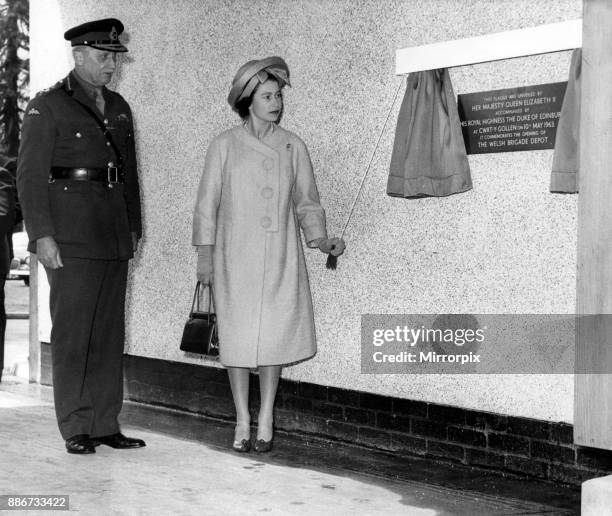 Queen Elizabeth II and the Duke of Edinburgh visit Wales. Pictured, Queen Elizabeth II unveiling a plaque to commemorate the opening of the Welsh...