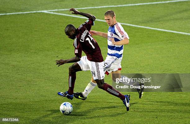 Omar Cummings of the Colorado Rapids tries to control the ball as Kyle Davies of FC Dallas defends during MLS action at Dick's Sporting Goods Park on...