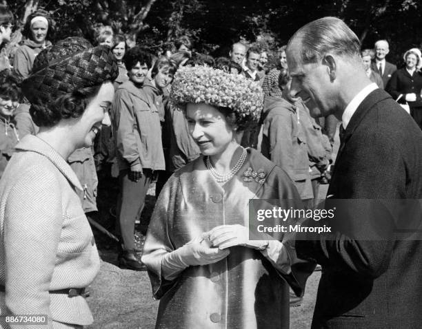 Queen Elizabeth II and the Duke of Edinburgh chatting with Miss A. Pen-Symons, the warden of the Girls Outward Bound School at Aberdovey, 10th August...