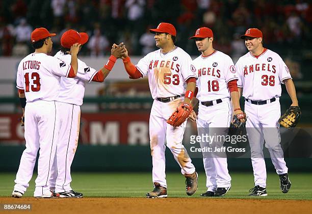 Maicer Izturis, Erick Aybar, Bobby Abreu, Sean Rodriguez, and Robb Quinlan of the Los Angeles Angels of Anaheim celebrate after defeating the...