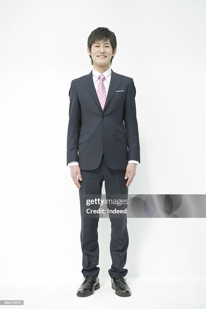 Portrait of young businessman, full length