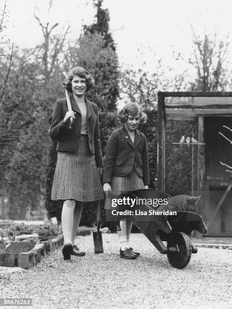 Princess Elizabeth and her younger sister Princess Margaret Rose in their garden at the Royal Lodge in Windsor Great Park, April 1940. The passenger...