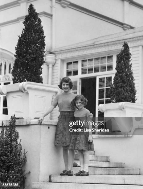 Princess Elizabeth with her younger sister Princess Margaret Rose on the terrace steps at the back of the Royal Lodge in Windsor Great Park, April...