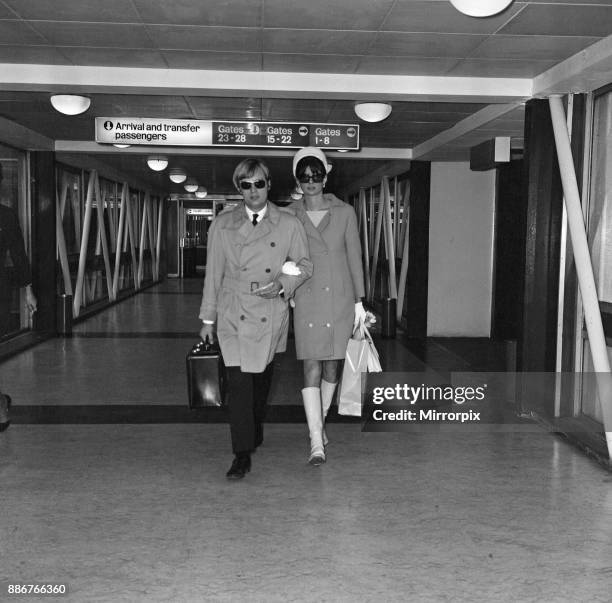 Actor David McCallum, one of the stars of the TV show 'The Man from U.N.C.L.E.' leaving Heathrow Airport for New York with his wife Katherine...
