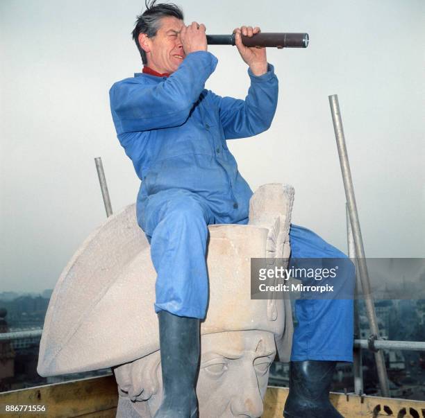 Nelson's Column being cleaned. Cleaner Ted Chambers on top of Nelson's Head, taking a break to survey the landscape of London through a telescope....