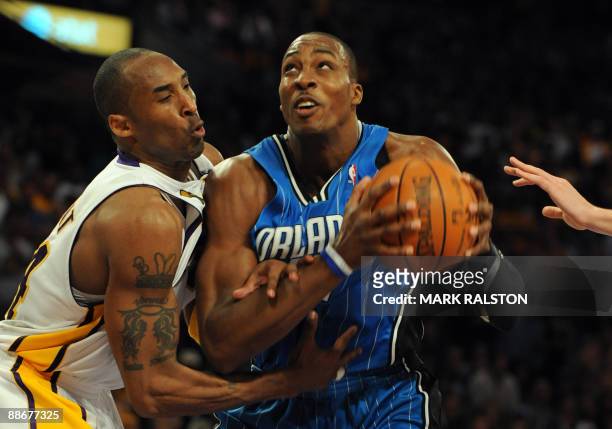 Kobe Bryant of the Los Angeles Lakers tries to stop Dwight Howard of Orlando Magic during game two of the NBA finals at the Staples Center in Los...