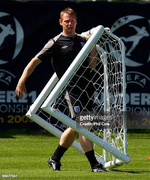 Stuart Pearce, manager of England moves some goal posts during a training session at the Ovrevi, on June 25, 2009 in Tvaaker, Sweden