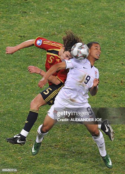 Spanish defender Carles Puyol vies with US forward Charlie Davies during the Fifa Confederations Cup semi-final football match Spain against the...