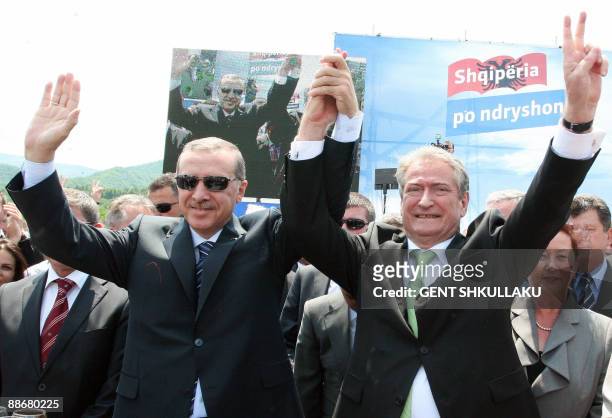 Albania's Prime Minister Sali Berisha and his Turkish counterpart Tayyip Erdogan greet the crowd during the inauguration of a highway between Albania...