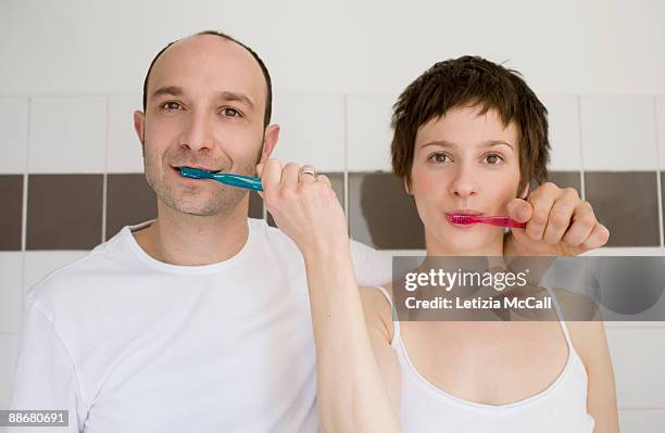 couple bruscing each other their teeth - geheimratsecke stock-fotos und bilder