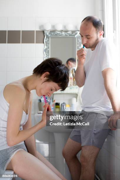 sleeping couple washing teeth - sleep hygiene stock pictures, royalty-free photos & images