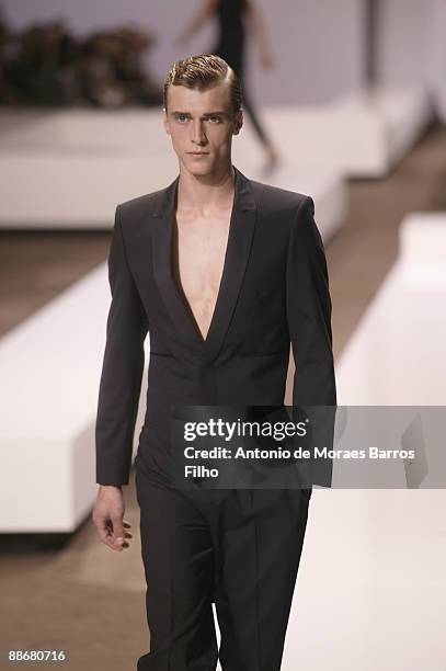 Model walks the runway during Hugo by Hugo Boss show as part of Paris Menswear Fashion Week Spring/ Summer 2010 at Halle Freyssinet on June 25, 2009...