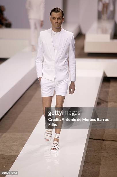 Model walks the runway during Hugo by Hugo Boss show as part of Paris Menswear Fashion Week Spring/ Summer 2010 at Halle Freyssinet on June 25, 2009...