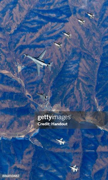 In this handout image provided by South Korean Defense Ministry, U.S. Air Force B-1B bomber , South Korea and U.S. Fighter jets fly over the Korean...