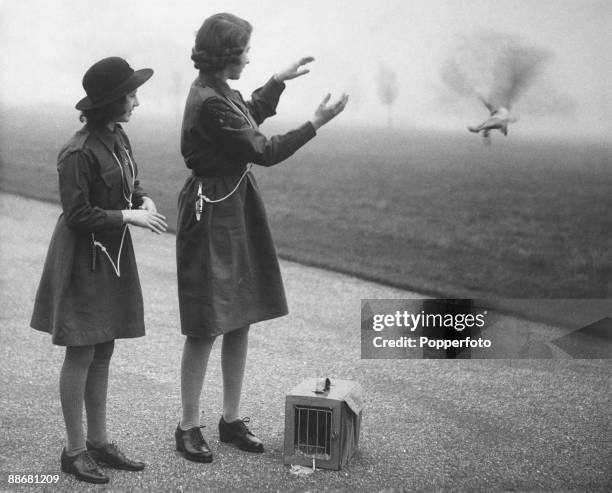 Princess Elizabeth and her younger sister Princess Margaret Rose release a carrier pigeon with a message to Chief Guide Lady Olave Baden-Powell on...