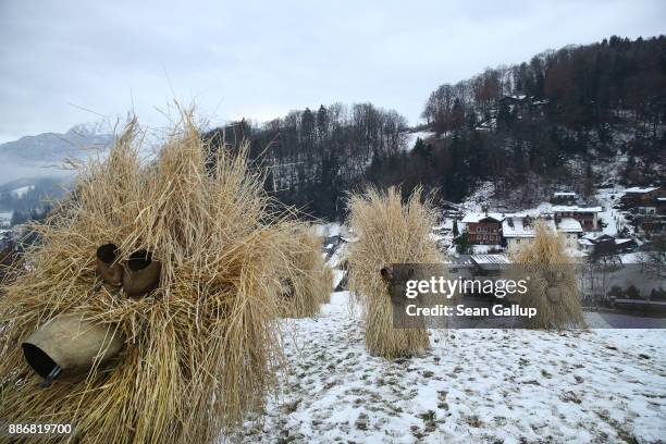 Men dressed in masks and straw in the form of a figure known locally as "Buttnmandl", or "Shaking Man", descend wearing cow bells on their backs...