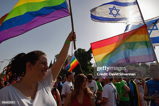 Israeli gays and lesbians wave their flags during the annual Gay Pride parade on June 25, 2009 in Jerusalem, Israel. Thousands of alternative...