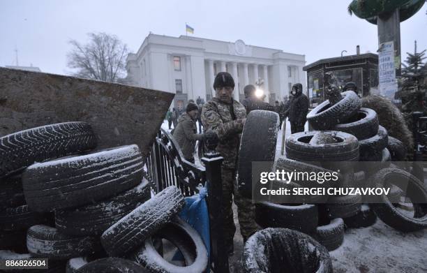 Activists set barricades at a camp of supporters of former Georgian president Mikheil Saakashvili in front of the Ukrainian parliament in Kiev where...