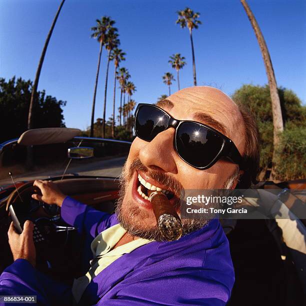 man driving convertible, smoking cigar, california, usa (wide angle) - best sunglasses for bald men fotografías e imágenes de stock