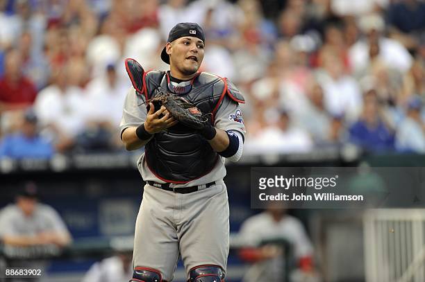 Catcher Yadier Molina of the St. Louis Cardinals fields his position as he catches a pop fly out in front of home plate during the game against the...