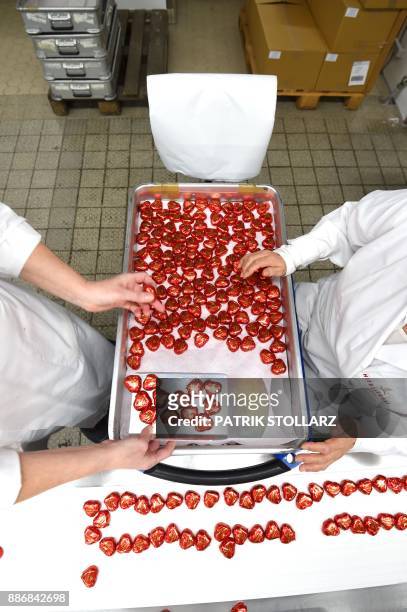 Heart-shaped marzipan pass along a conveyor belt at the headquarters of the traditional confectionary maker JG Niederegger GmbH in Luebeck, Germany,...