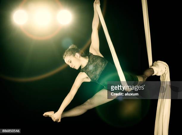 aerial dancer performance with silks - acrobat performer stock pictures, royalty-free photos & images