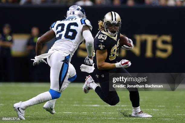 Willie Snead of the New Orleans Saints runs with the ball as Daryl Worley of the Carolina Panthers defends during a game at the Mercedes-Benz...