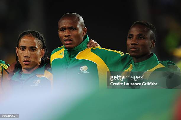 Steven Pienaar , Kagisho Dikgacoi and Teko Modise of South Africa line up prior to the FIFA Confederations Cup Semi Final match beween Brazil and...