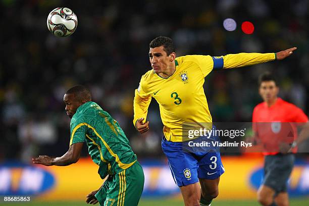 Bernard Parker of South Africa is beaten to the ball with Lucio of Brazil during the FIFA Confederations Cup Semi Final match beween Brazil and South...