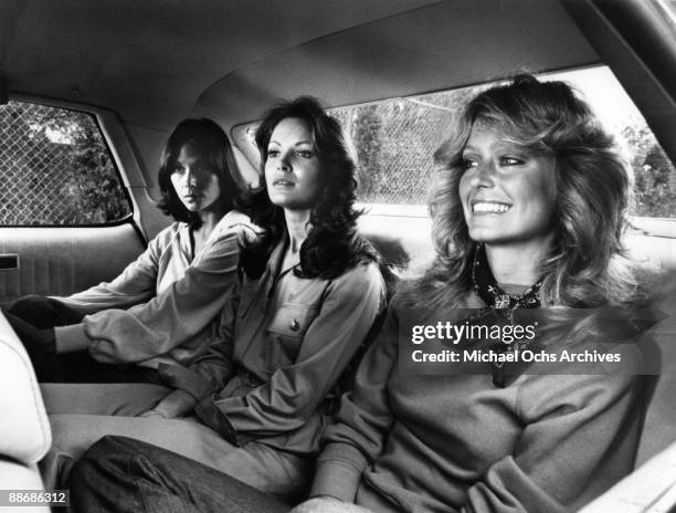 Kate Jackson, Jaclyn Smith and Farrah Fawcett ride in the back of a car while filming a scene for Charlie's Angels circa 1977 in Los Angeles,...