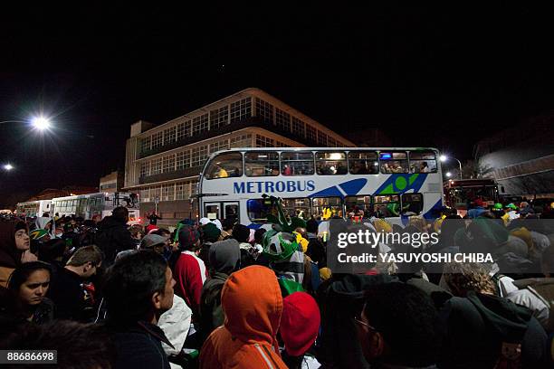 South Africans wait to board buses outside the Ellis Park stadium after the Fifa Confederations Cup semi-final football match Brazil against South...