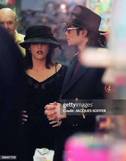 This September 3, 1994 file photo shows US pop star Michael Jackson and his then wife Lisa-Marie Presley visiting a toy shop in Cannes. Jackson died...