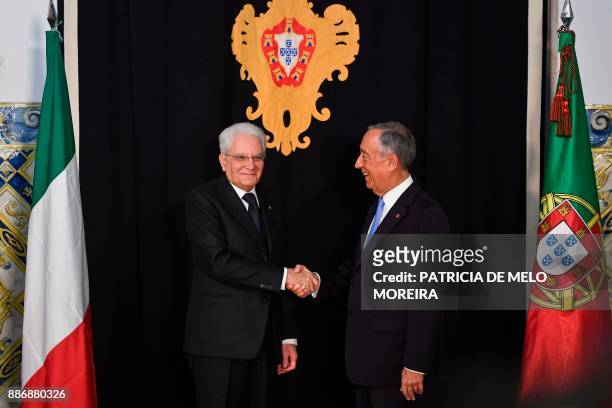 Portuguese President Marcelo Rebelo de Sousa shakes hands with his Italian counterpart Sergio Mattarella at Belem palace in Lisbon on December 6,...