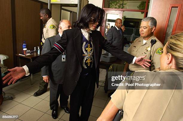 Michael Jackson is scanned for metal objects as he arrives at the Santa Maria Courthouse for defense testimony in his child molestation trial May 23,...