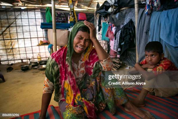 Dildar Begum becomes emotional while her 10 year old daughter, Nurkalima, looks on, on December 3, 2017 in Cox's Bazar, Bangladesh. She fled to...