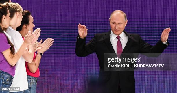 Russian President Vladimir Putin arrives to give a speech at a forum of volunteers in Moscow on December 6, 2017.