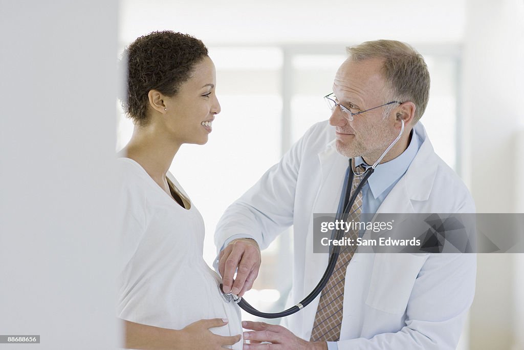 Doctor giving pregnant woman check-up