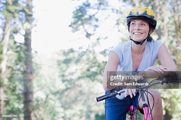 bike rider relaxing in forest - woman bicycle stock pictures, royalty-free photos & images