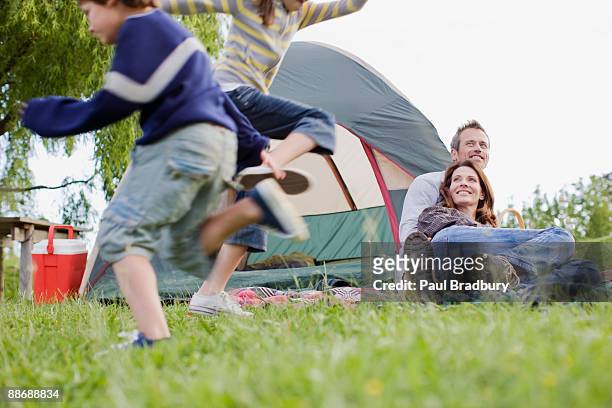 family camping in remote area - mom flirting stockfoto's en -beelden