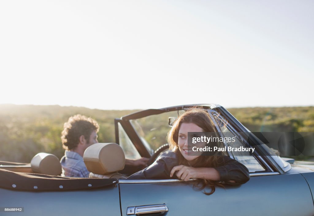 Couple driving in convertible