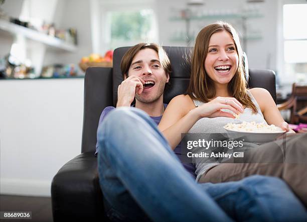 couple watching television and eating popcorn - couple tv bildbanksfoton och bilder