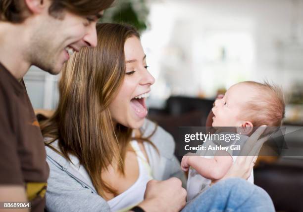 couple smiling at newborn baby - surprised mum stock pictures, royalty-free photos & images