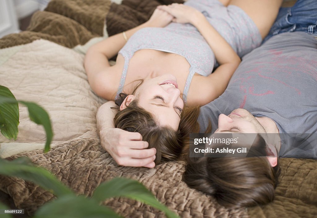 Couple laying on bed together