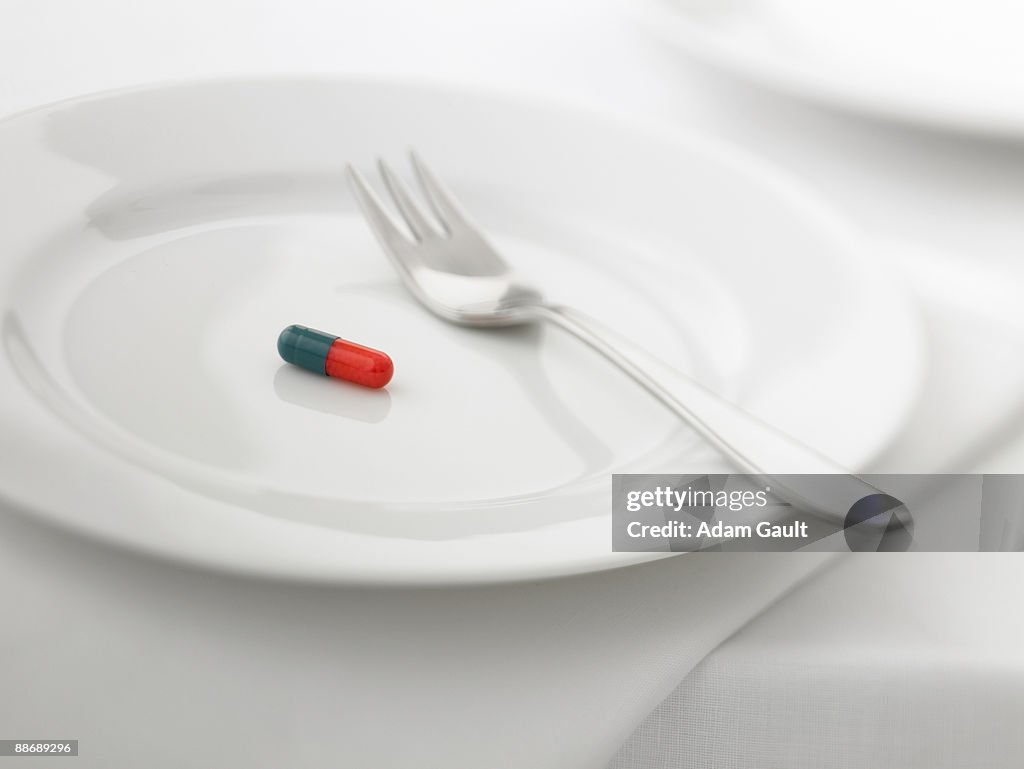 Close up of pill capsule on plate