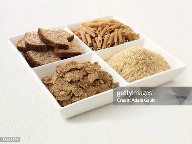 close up of sectioned plate with bread, pasta, rice and cereal - carbohidrato fotografías e imágenes de stock