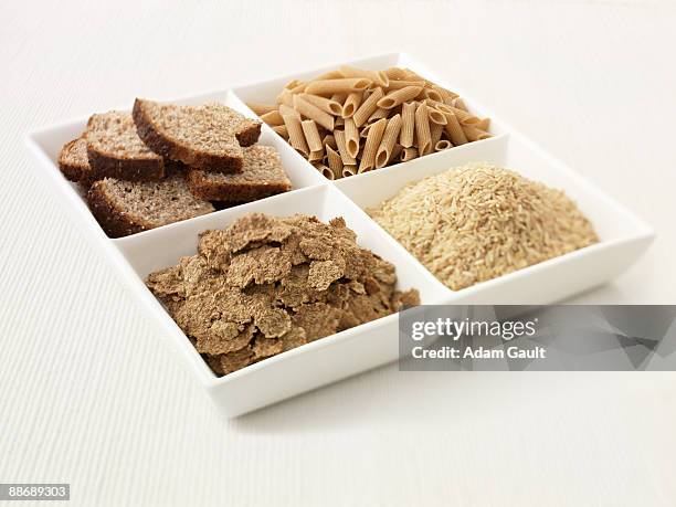 close up of sectioned plate with bread, pasta, rice and cereal - wholegrain foto e immagini stock