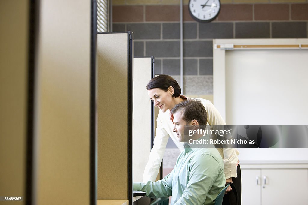 Teacher helping student at desk